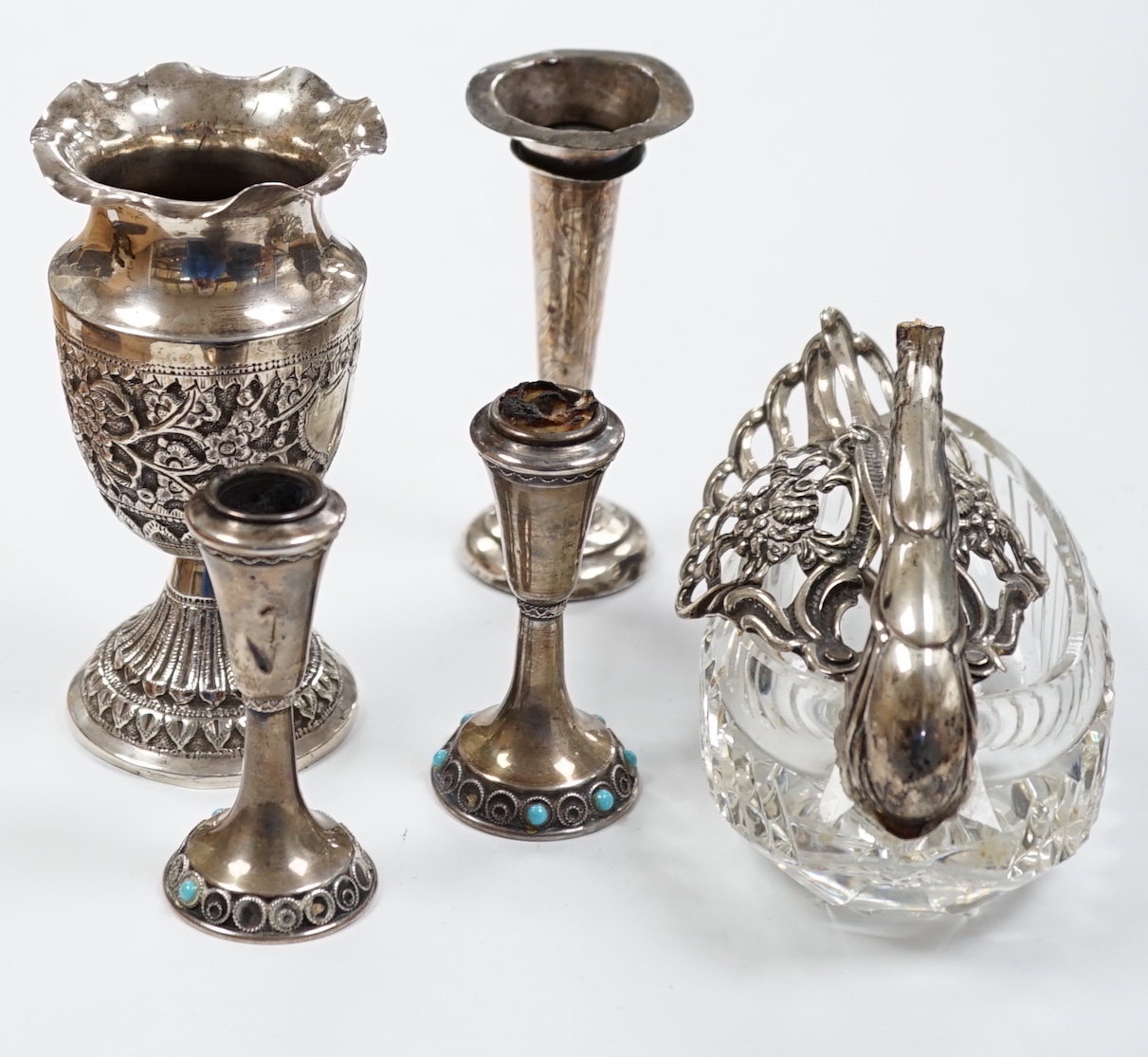 Two small white metal candlesticks, 8cm, an Indian vase, silver posy vase and a white metal mounted glass swan dish, a.f.
